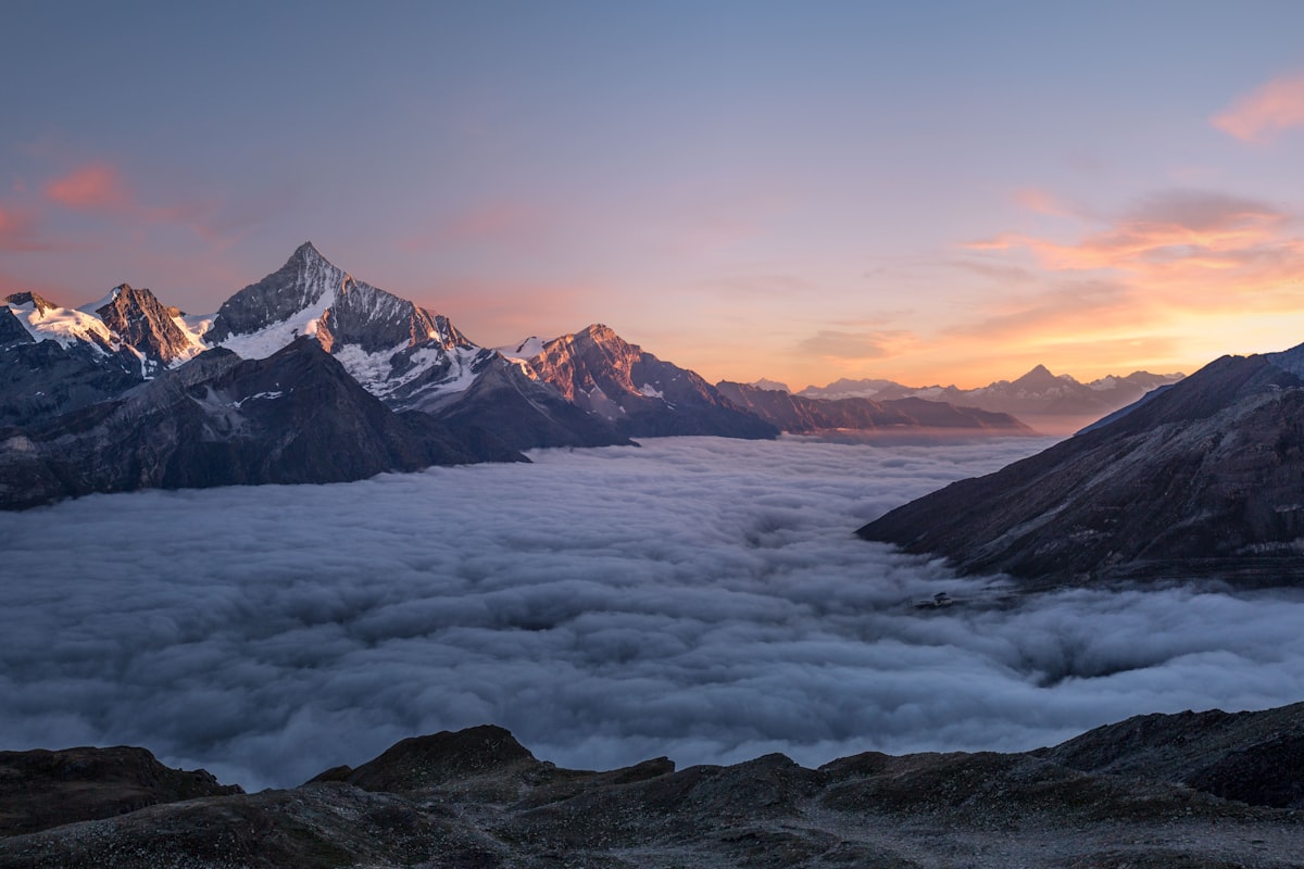 Snow-capped mountain peaks at sunrise